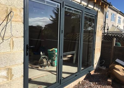 grey aluminium ali bi fold doors with blinds in glass