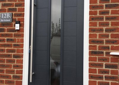 Slate grey Truedor composite door with bar handle